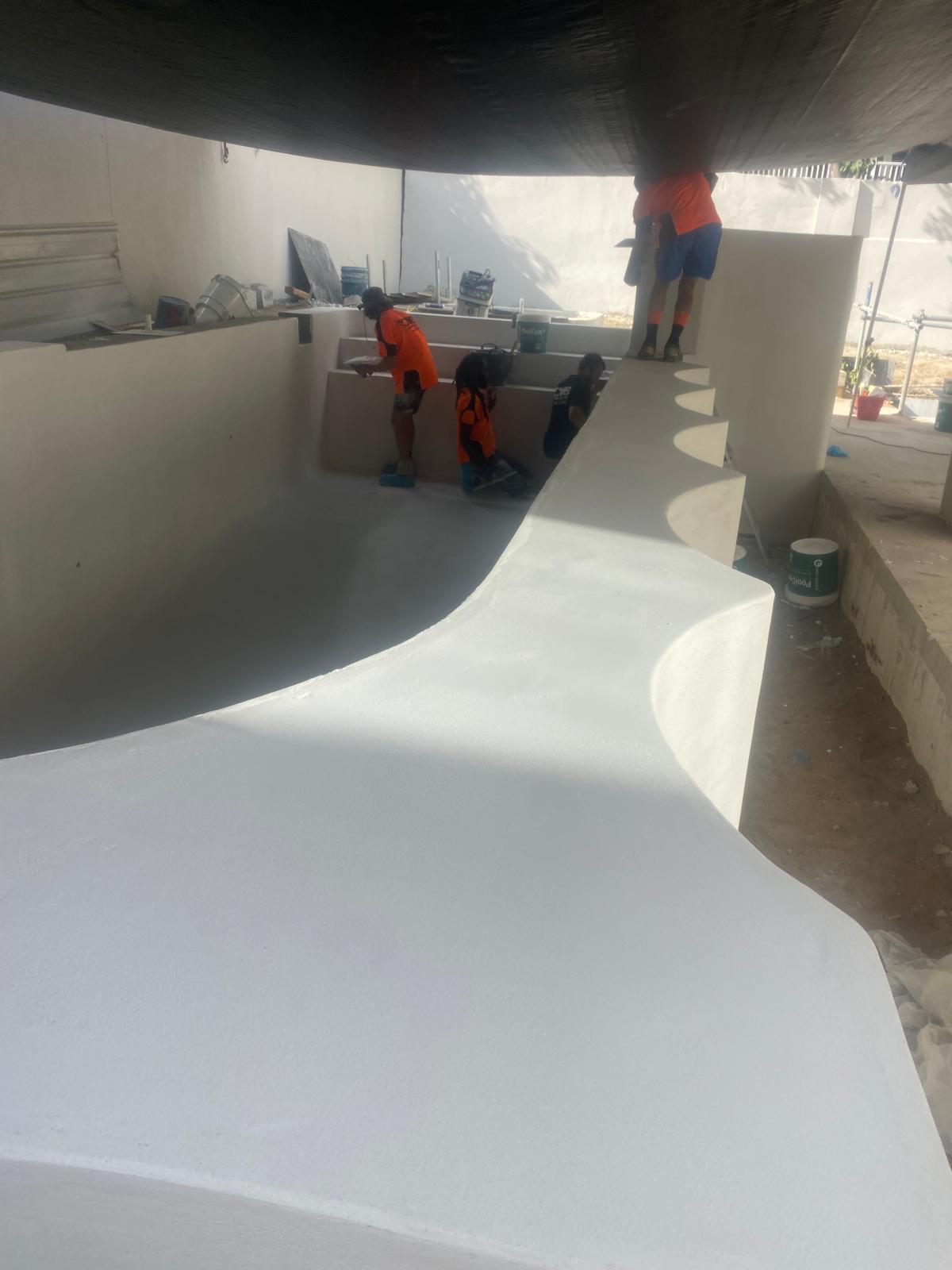 Empty pool shell finished in smooth grey microcement